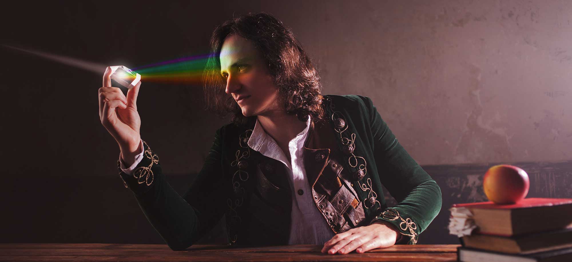 Scientist observing coloured light with a prism.